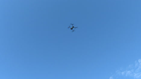 Footage-of-a-DJI-drone-ascending-quickly-into-a-blue-sky