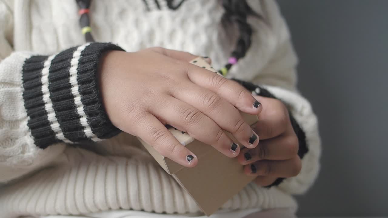 Child's Hands Opening and Closing a Small Gift Box