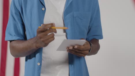 man stands at ballot box in american election deciding how to cast his vote 3