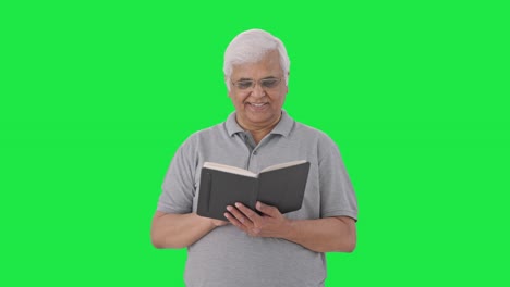 happy indian old man reading a book green screen