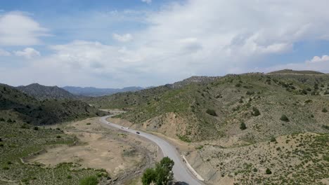 Paktia's-Afghan-mountains,-seen-by-drone,-split-by-road