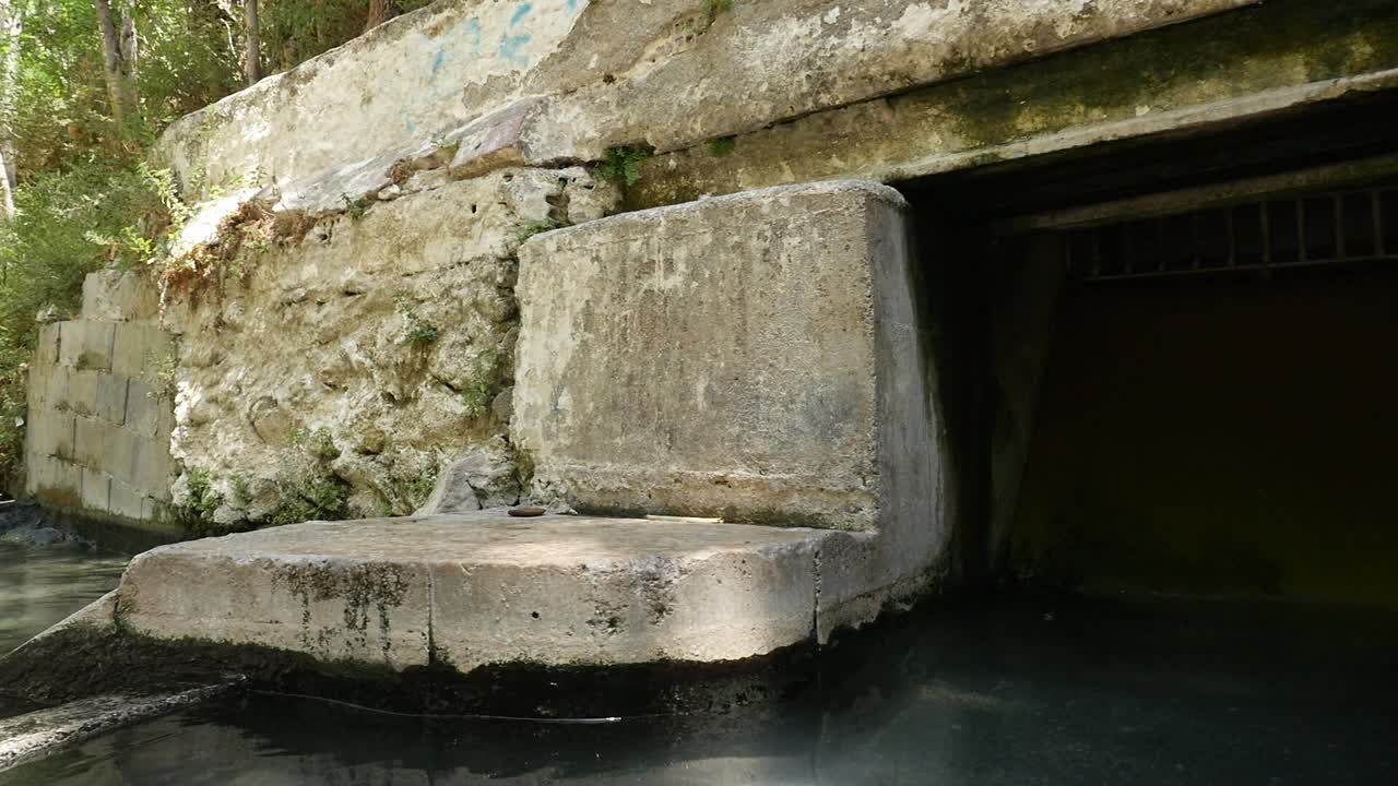 Hot springs in the natural pools of Alhama de Granada. Medicinal water flowing from an ancient structure