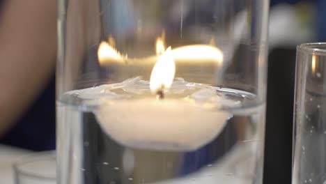 floating candles on glass with reflections. close-up