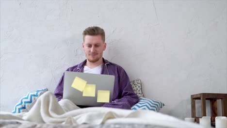 Man Working From Home on a Laptop in Pajamas