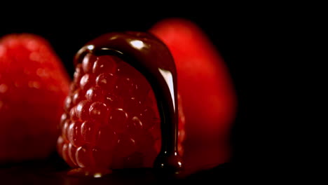 Melted-chocolate-pouring-over-raspberries