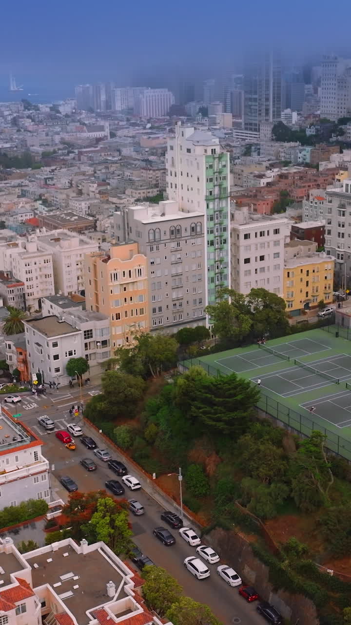 Mist covering the city panorama. Dense urban panorama of beautiful San Francisco from aerial view. Ocean at backdrop. Vertical video