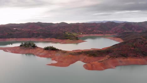 cloudy sky and low water levels on a reservoir due to extreme drought