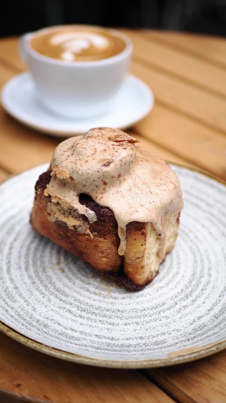 Sweet Cinnamon Roll with Coffee on a Wooden Table
