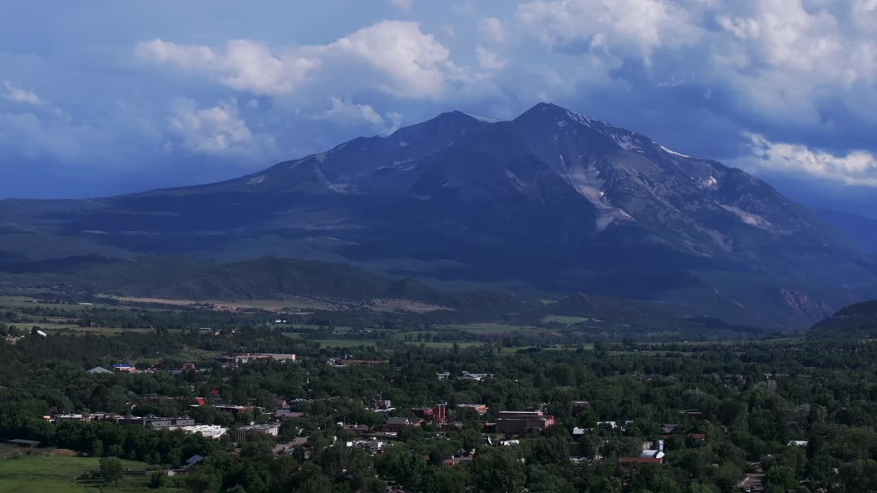 Carbondale Mount Sopris Spores Marble Basalt Aspen Snowmass El Jebel summer aerial drone Colorado June July Rocky Mountain snow cap peaks Marble cloudy sunny daytime Roar Fork River circle left motion