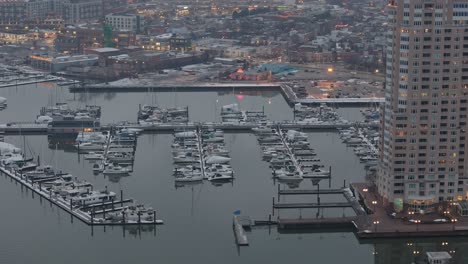 Aerial-View-of-Large-Port-in-Downtown-Baltimore-full-of-Boats,-Foggy-Day