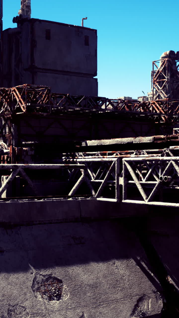 Industrial landscape with weathered structures under clear blue sky