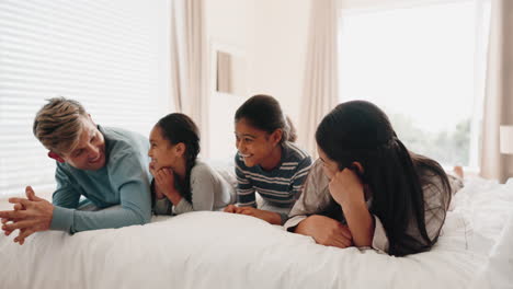 Happy-family,-bed-and-kids-playing-in-a-bedroom