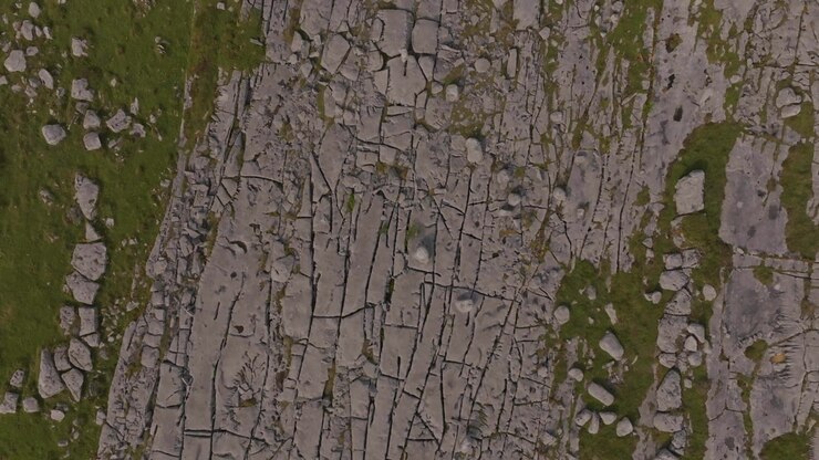 A high angle top down shot of the unique karst limestone landscape in The Burren, County Clare, Ireland. Showcases natural geological patterns and ecofriendly tourism.