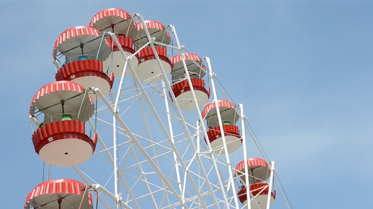 Brightly colored Ferris wheel against the blue sky