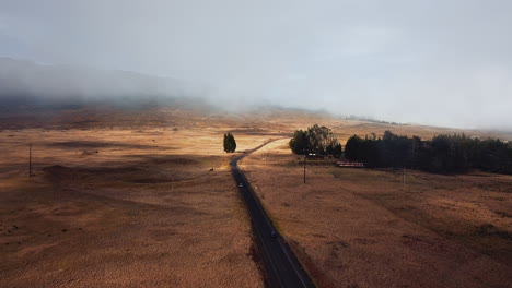 aerial view of a scenic road through a foggy mountain landscape