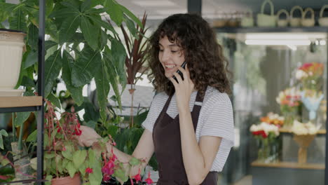 woman florist talking on phone in a plant shop