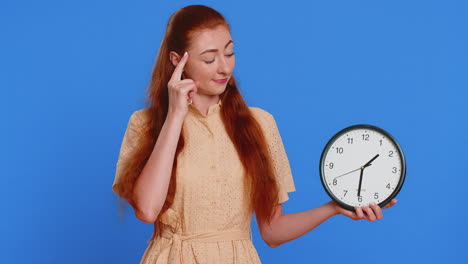 redhead adult woman girl showing time on wall office clock ok thumb up approve deadline hurry up
