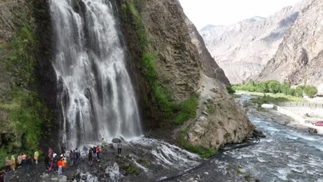 happy tourists enjoy at a waterfall