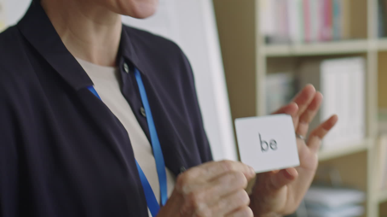 Female English Teacher Explaining Word Card during Lesson