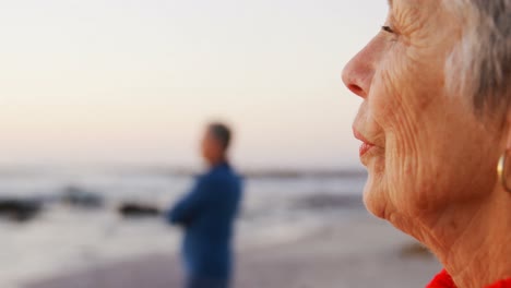 Senior-couple-standing-in-the-beach-4k