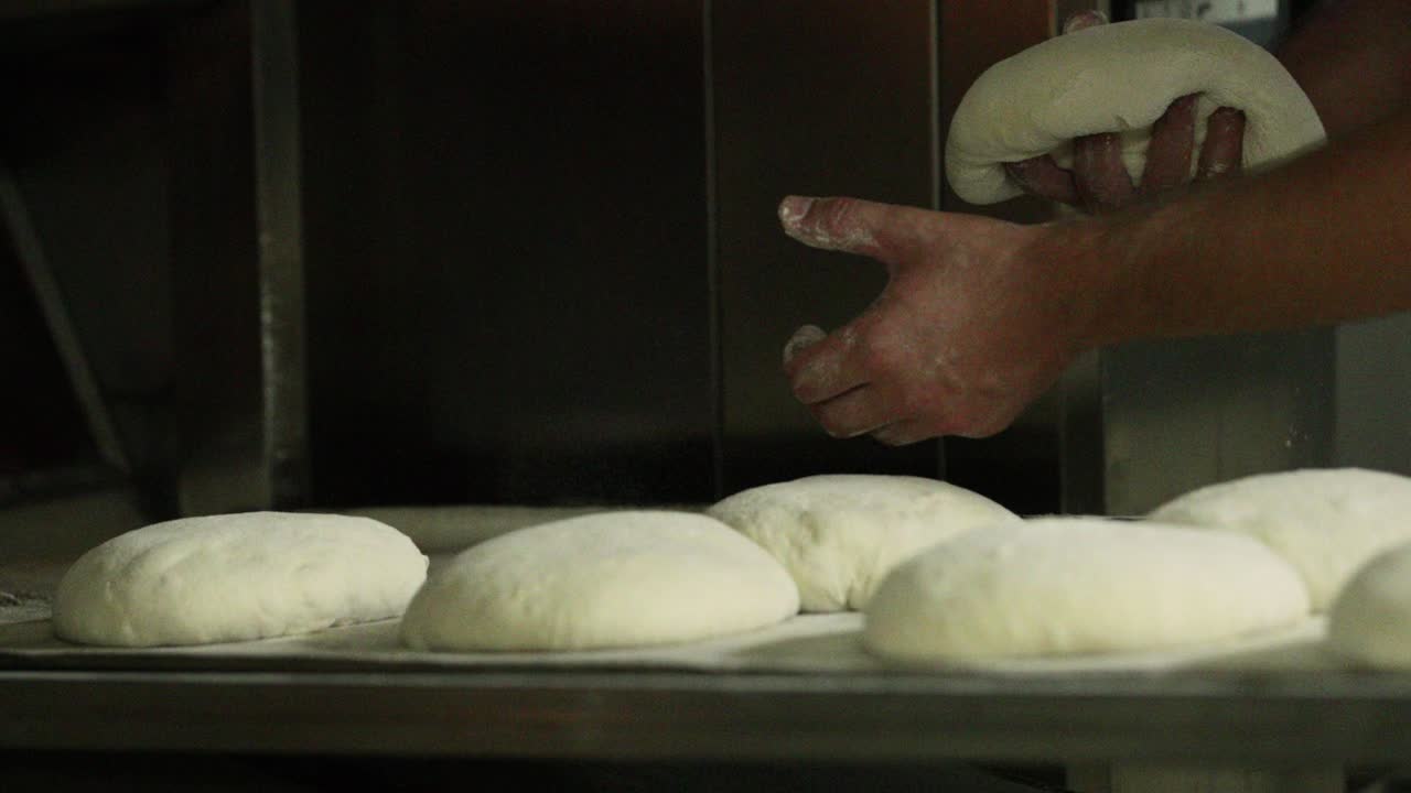 Placing Bread Dough Dusted With Flour On A Baking Tray