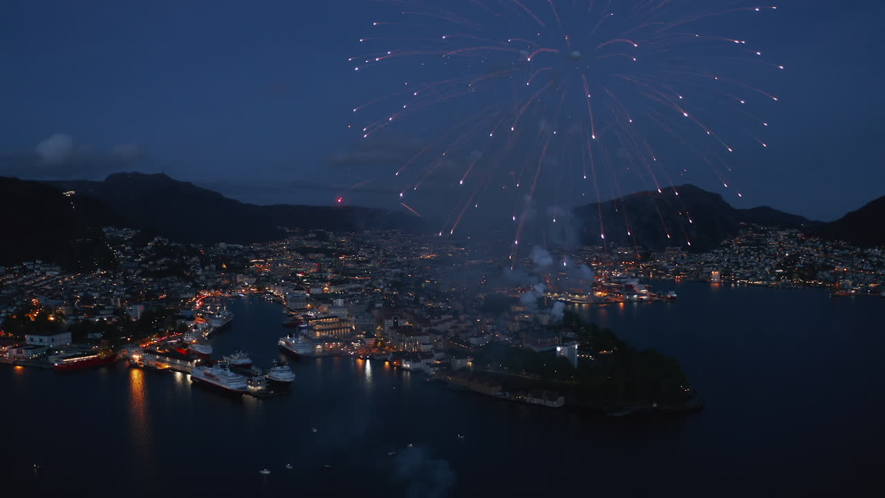 Beautiful close-up aerial shot of fireworks over Bergen, Norway on the constitution day May 17