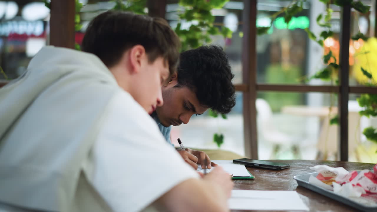 Young lad in white polo carefully applying ink strokes onto paper, focused on precision sketch, capturing creative process under soft light with dynamic hand movement, showcasing artistic technique