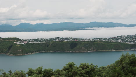 Airplane-flying-over-water-getting-ready-to-land-in-Wellington,-New-Zealand