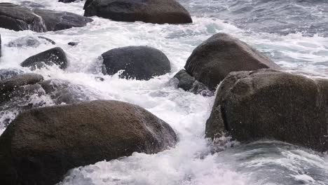 waves crashing against rocks on a rocky shore