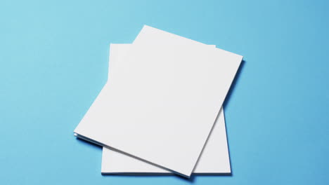 video of books with white blank pages and copy space on blue background