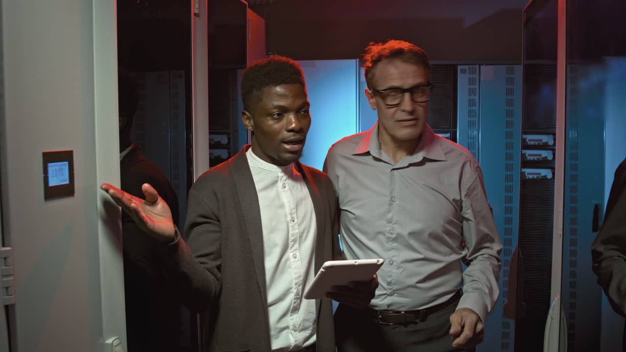 Colleagues Talking and Walking through Data Center