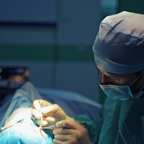 doctor doing blepharoplasty on a face. profile view of a surgeon in blue mask performs a cosmetic procedure on upper patient's eyelid.