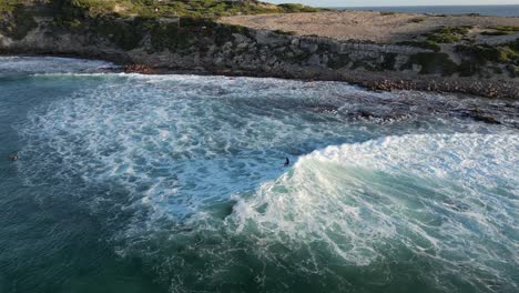 surfer surfing wave at sunset, gracetown area in western australia