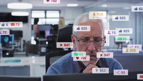 social media notifications animation over focused elderly man working in office