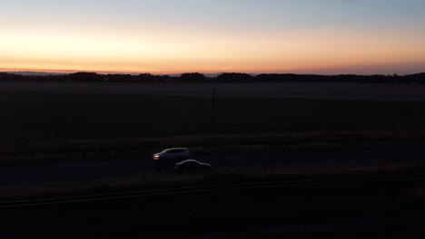 orbital pan around figure and car at sunset
