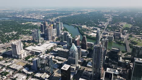 aerial view of a vibrant city skyline with a river flowing through it