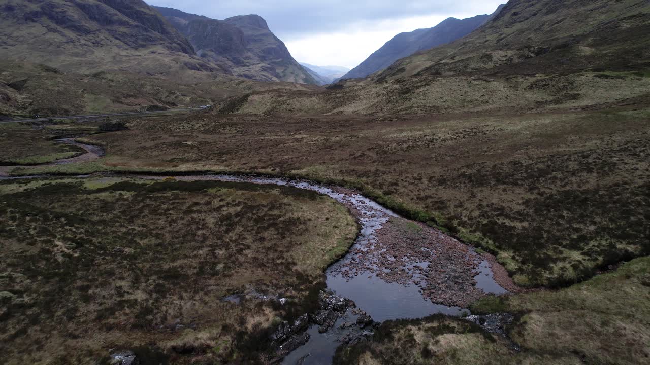 Epic aerial reveal shot of Glencoe valley and mountains in the scottish highlands