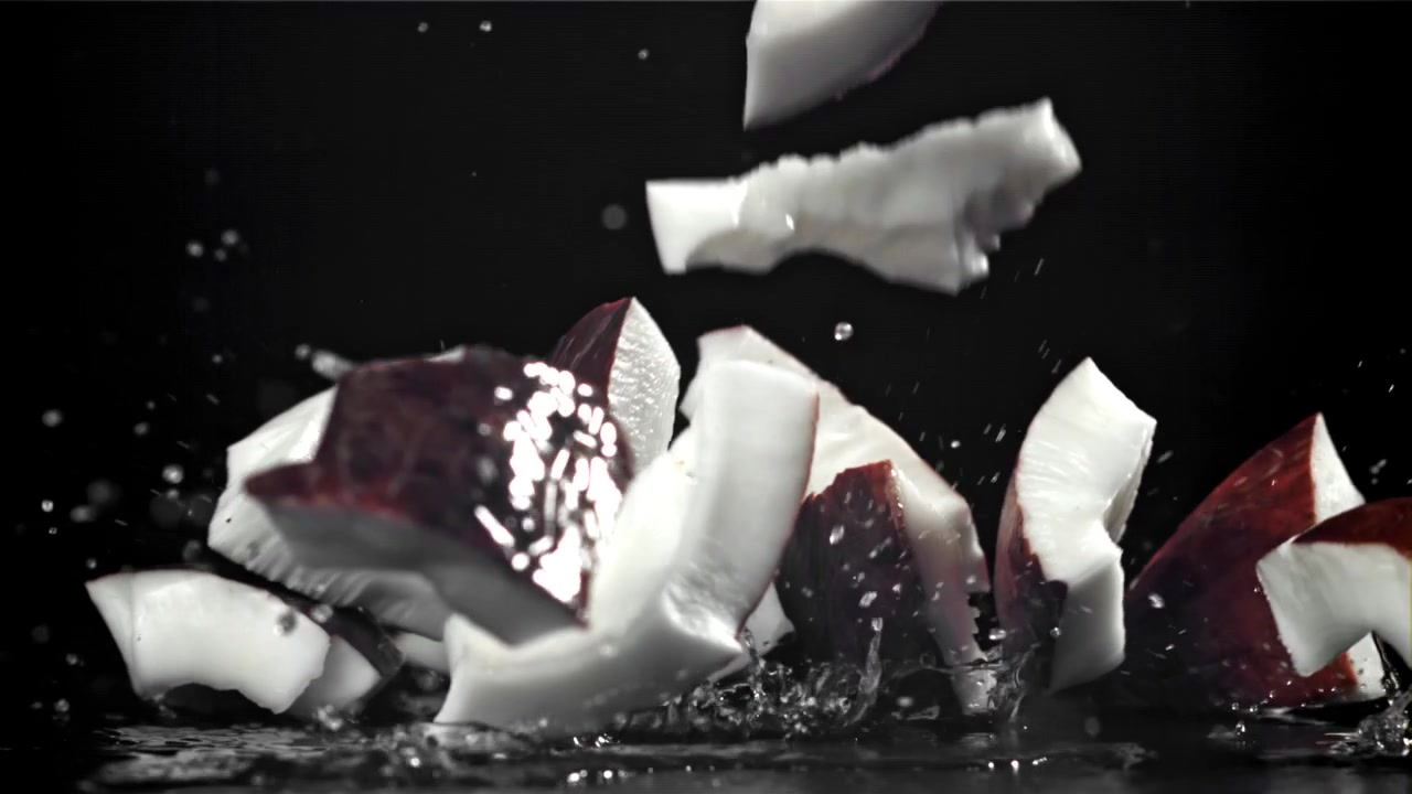 Coconut Pieces Splashing into Water in Slow Motion