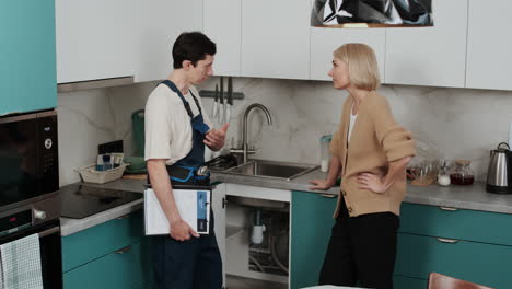 woman talking with plumber