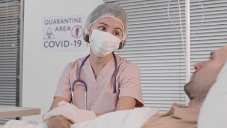 joven médico tranquilizando al paciente en la sala