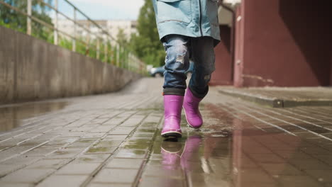 kid races through puddles near entrance active child finds joy in active play on rainsoaked streets