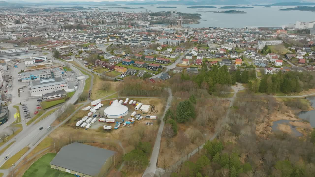 High-altitude drone shot captures circus tent and crowd from above.