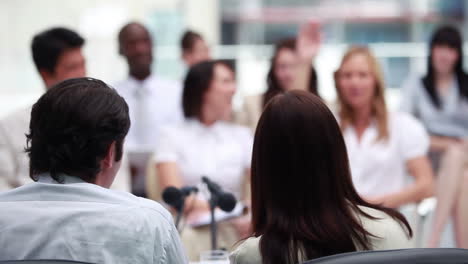 Woman-whispering-to-her-colleague