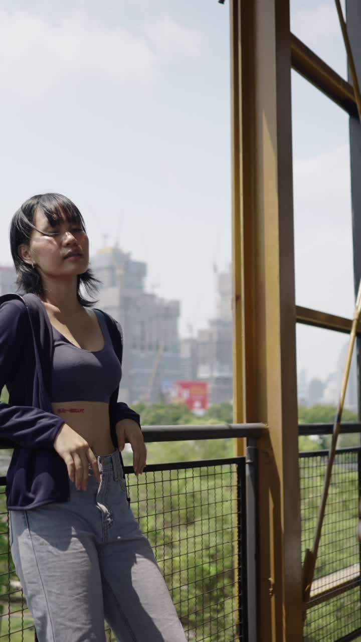 Woman posing in front of cityscape