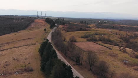Aerial footage of electric high voltage power transmission towers on a field 4