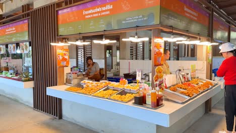 customer buying snacks at a vibrant stall