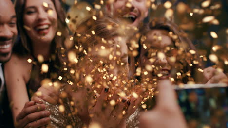 beautiful woman blowing glitter at glamorous party