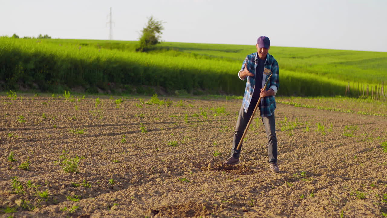 Farmer Digging and Tilling Soil in an Agricultural Field