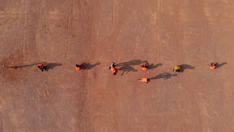 drone shot of school kids playing indian sports kho-kho in sed sand of maharashtra