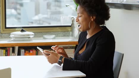 Woman-using-digital-tablet-at-table-4k